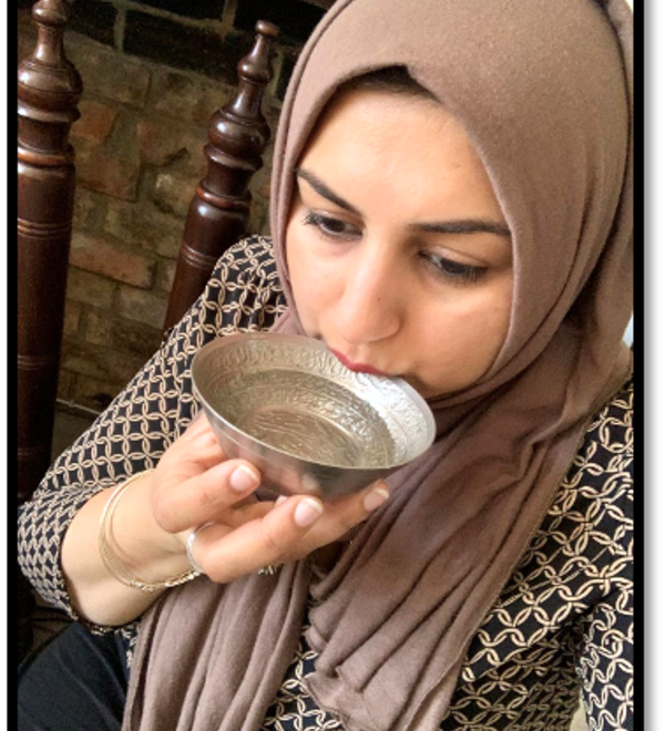 Multaka Volunteer Marriam drinking from her Healing Bowl, a gift from her father