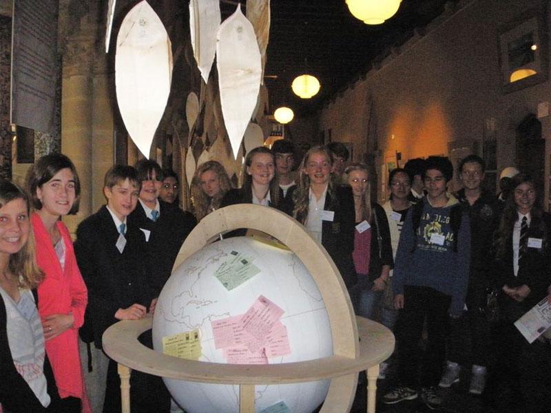 Winners of Activity photo showing Dux Awards Scheme students with the globe