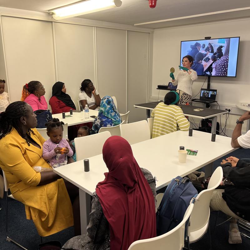 Curator sharing objects linked with Africa from the Museum's collection with AfiUK Boma group